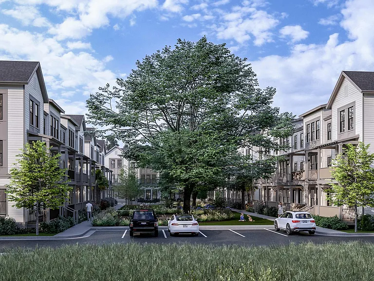 The private courtyard at Fenland Townhomes offers a peaceful retreat with majestic oak trees and inviting seating areas.