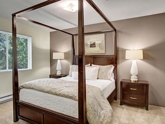 Bedroom with bed, desk, and window