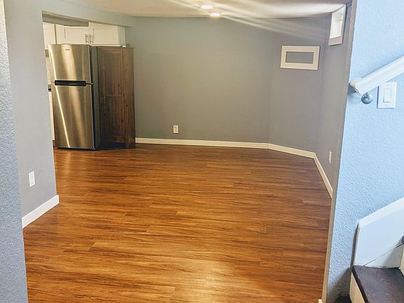 View of the living room and dining area from master bedroom. Water main shut-off for entire house/both units in this living space.