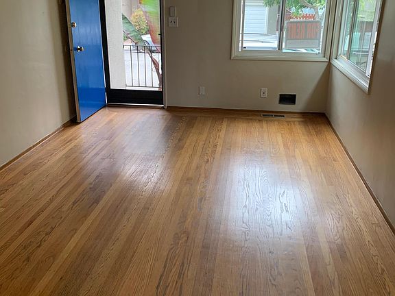 Living room with hardwood floors and tons of natural light from vinyl windows