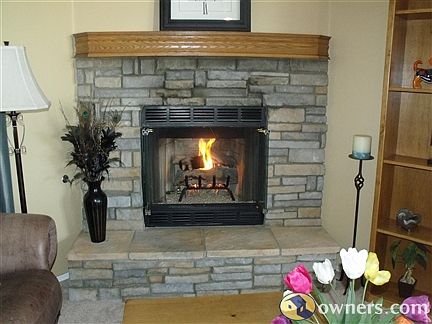 Beautiful Rock Gas Fireplace with Oak Mantel