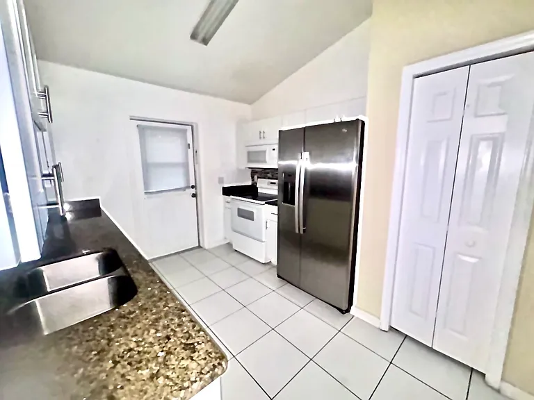 Picture of the kitchen and newer stainless steel refrigerator(about 1 year old)