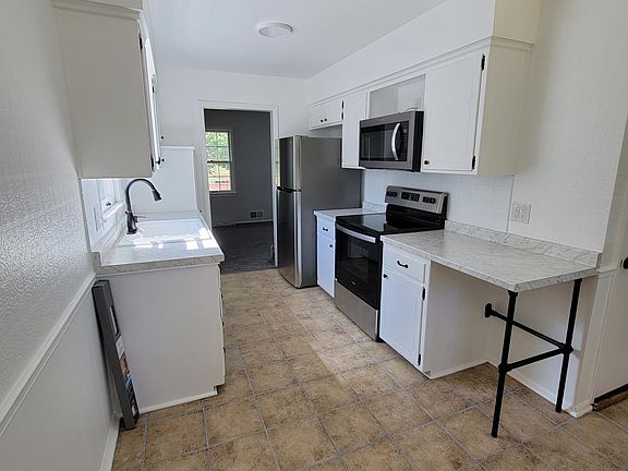 Kitchen with Stainless steel appliances.