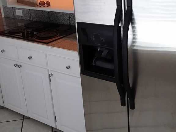 Large stainless steel refrigerator in kitchen