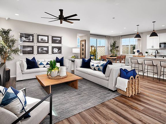 A photo of the great room with a view of the kitchen and dining in the Plan 3 model home at Dwell.