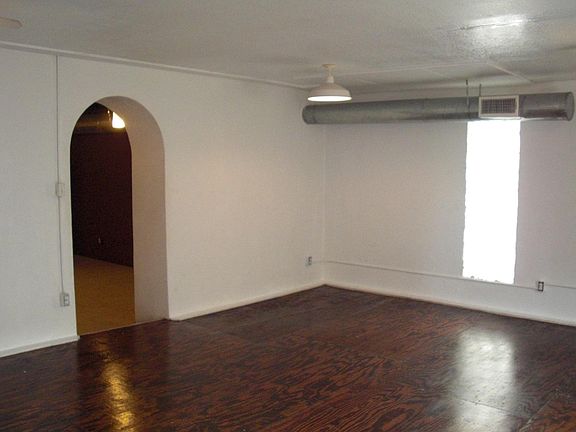 Front room; arched entry to back area.