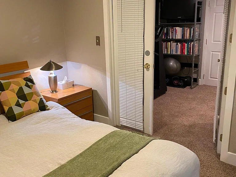 Bedroom looking into hallway/exercise area