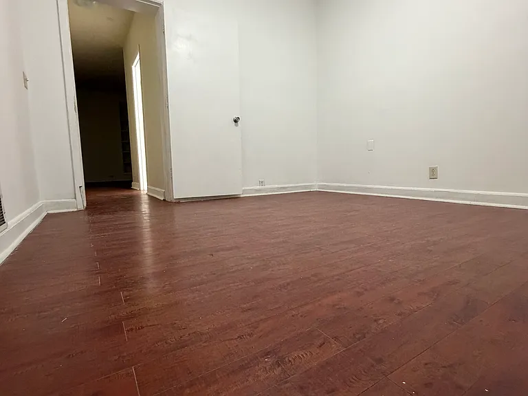 3rd bedroom. ceiling fan. hardwood floors. hallway shows proximity to bathroom.