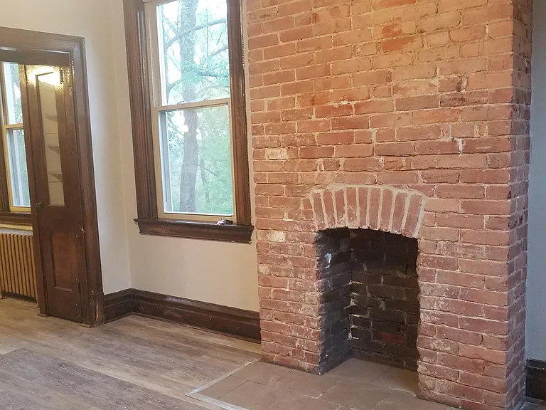 Brick fireplace in living room.