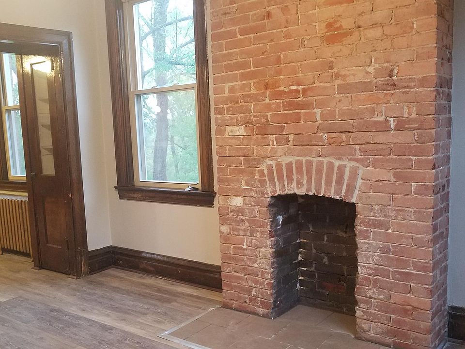 Brick fireplace in living room.