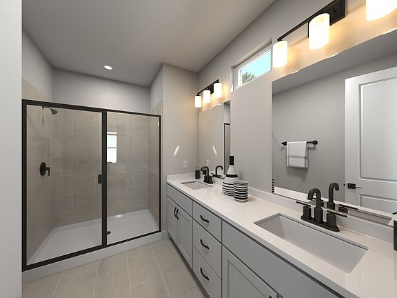 The primary bathroom offers dual vanity sinks and a walk-in shower.