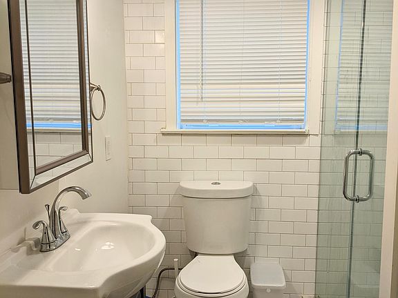 Fully renovated bathroom with glass shower door
