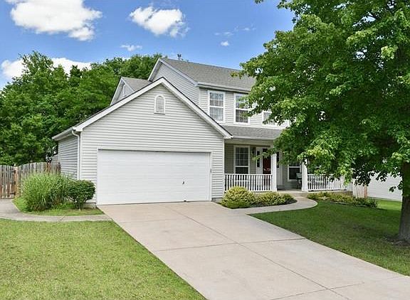 Another view of the front of the home with a sidewalk leading to the back yard.