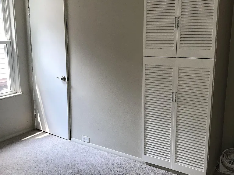 3rd bedroom. It faces the backyard and lilypad garden. The storage systems are great for making this an office.