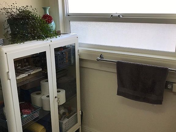 Bathroom has room for extra cabinet to store items (cabinet not included in unit).