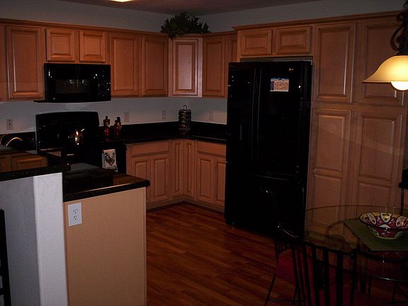 new kitchen with maple cabinets, granite and laminate wood floors