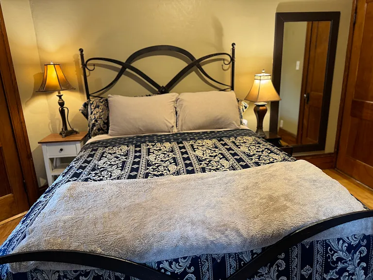 This queen size bed was purchased at Arhaus Furniture, in Natick, Massachusetts. The comfortable mattress is dressed with luxurious soft bedding. Having a full length mirror is such an appreciated accessory by many_