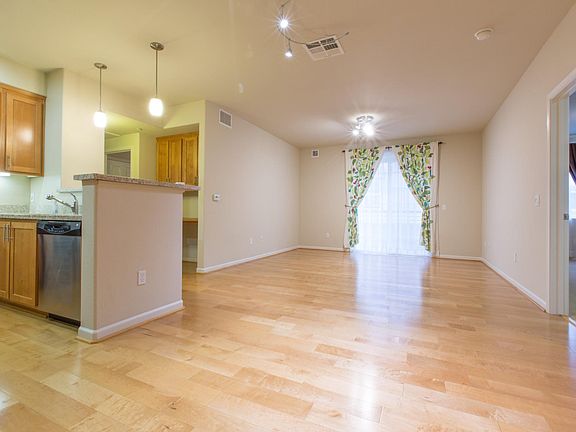 Dining/Living Room and Kitchen. Door to Primary Bedroom on the right.