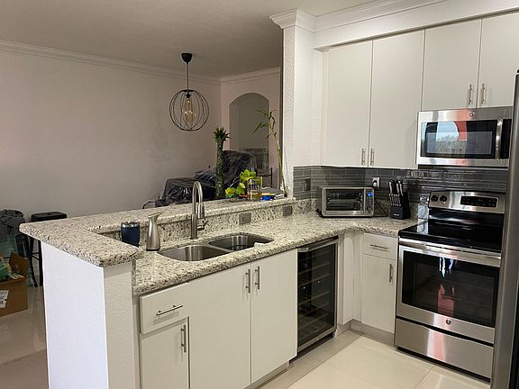 Kitchen with wine cooler installed. All stainless steel appliances