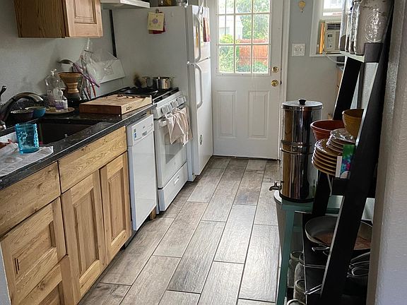 Granite kitchen with plank tile floor, new gas stove, dishwasher, full size refrigerator and coffee bar!