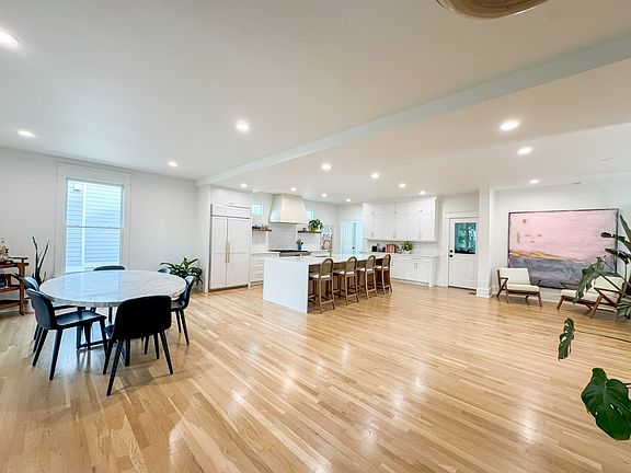 Just off the kitchen, the dining area features a Restoration Hardware marble table. The layout blends elegance and comfort across the open-plan main floor.