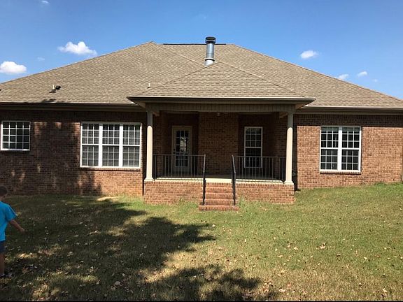 Covered patio overlooking fenced in backyard