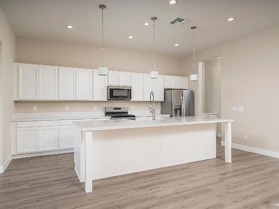 Beautiful white kitchen with stainless steel appliances