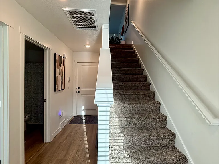 Hallway to garage/stairs to main living area