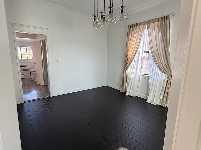 View from the Front Entrance Staircase Showcasing the Hallway with Access to the Dining Room and Kitchen.