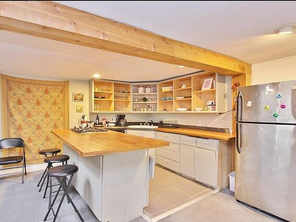 Chef's kitchen with tile floor, wood counters and newish appliances