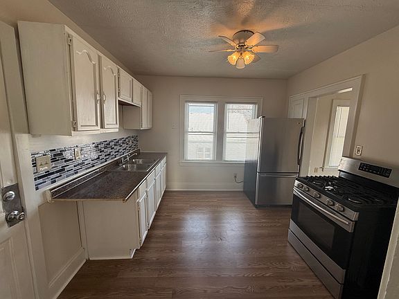 Kitchen with gas stove and LG stainless steel refrigerator.