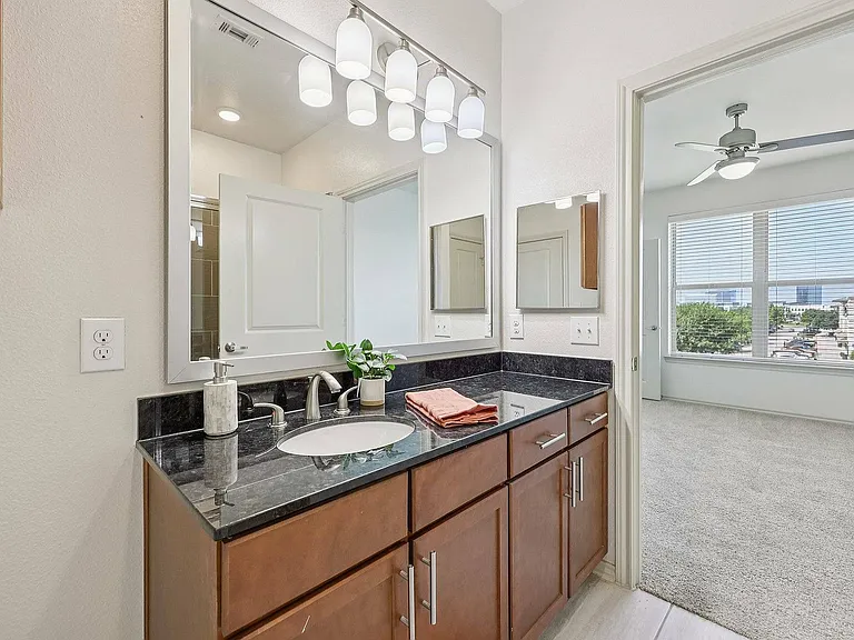 Spacious bathroom with upgraded finishes and a glass-enclosed shower.