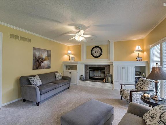 Generous family room is open to kitchen and breakfast room.  Cabinets offer extra storage.  Enjoy views of the backyard.