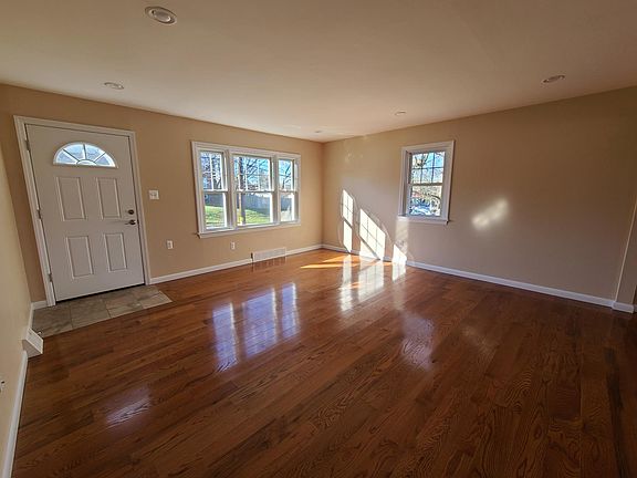 The living room features a ceramic tile entrance and the entire first level was upgraded with solid oak hardwood floors.