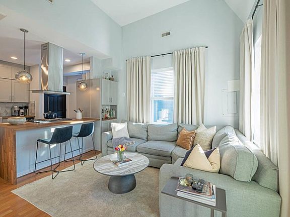 Large living room with a chefs kitchen, bar seating, and an open concept design. Cook and entertain at the same time.