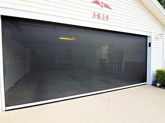 Garage was extended 7 feet longer and 4 feet wider, comes equipped with automatic roll down screen and lots of built in cabinetry.