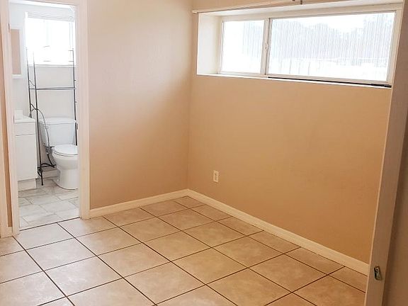 The living area has a second ceiling fan and A/C unit, plus additional overhead storage