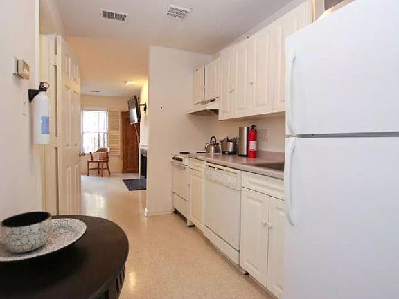 Galley Kitchen with dishwasher, full fridge, microwave, toas