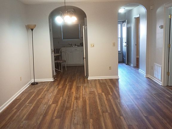 most set up a dining table under the hanging light and set the couch up closer to the side of the room with the ceiling fan.