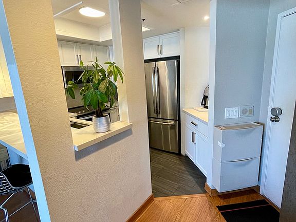 Renovated kitchen with shoe storage in the entry