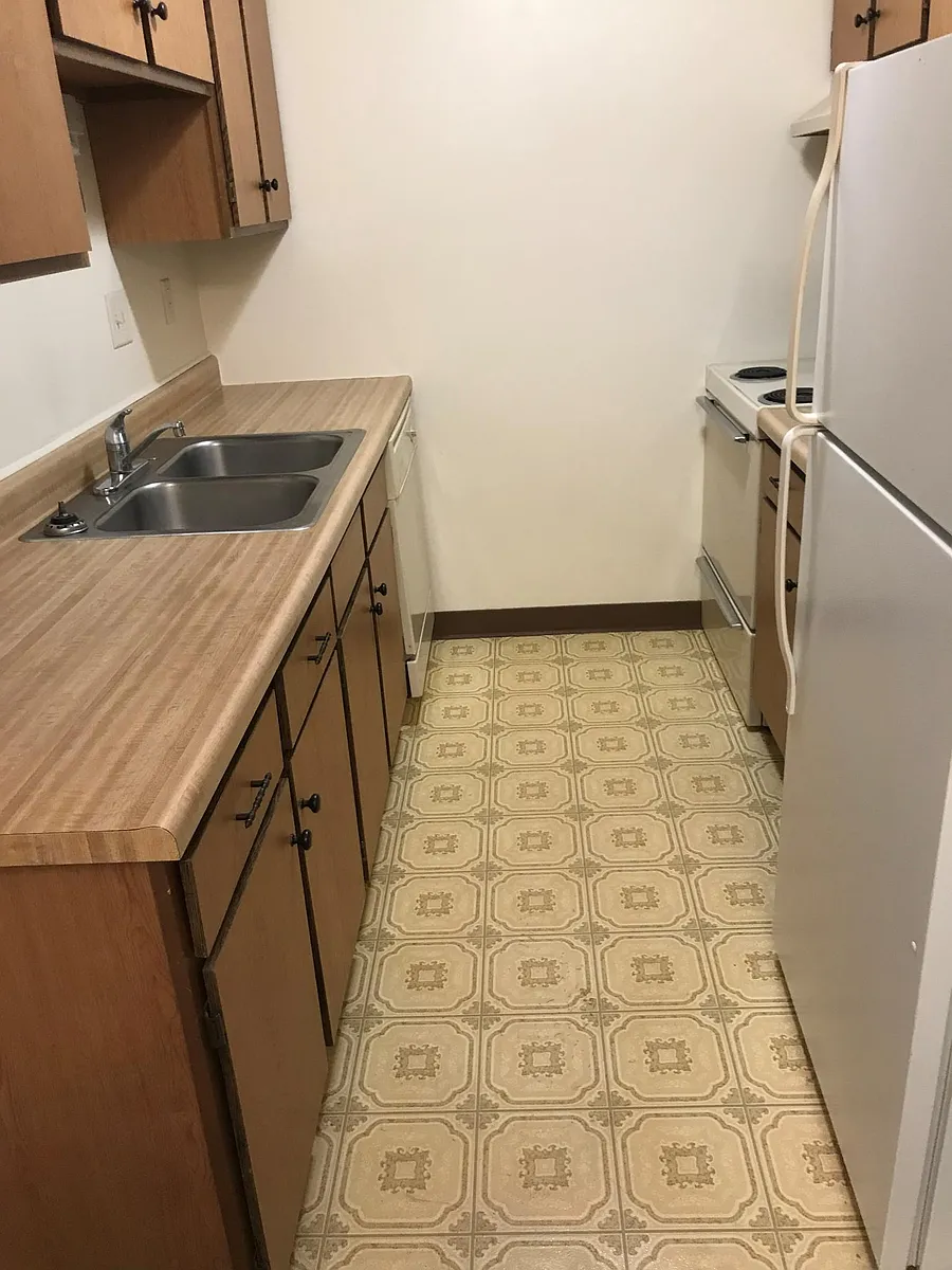 Functional kitchen with dishwasher, plenty of cabinet space and refrigerator. - 1900 S 13th St #17-4