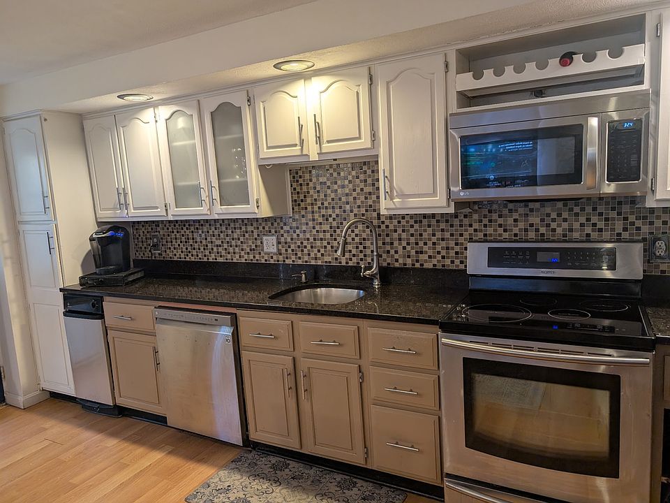 Kitchen with induction range, dishwashwer, trash compactor, microwave and plenty of storage