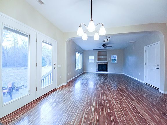 Family Room & Dining Area with patio doors and picture window looking into back yard.