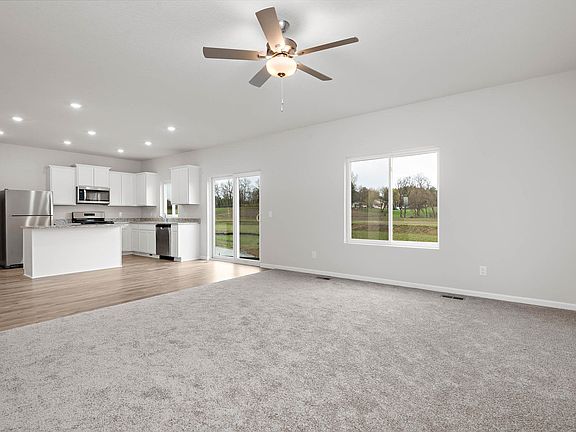 The family room is spacious with a ceiling fan.