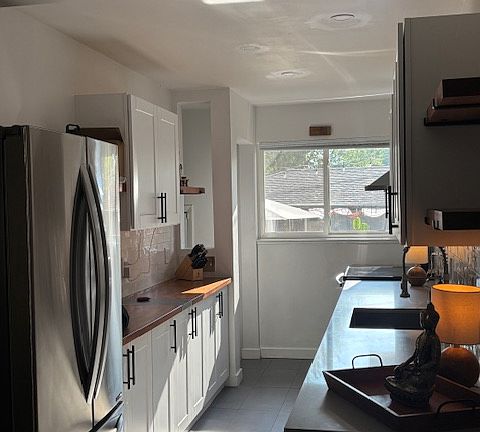 Open and bright updated kitchen with newer stainless appliances and brand new dishwasher.