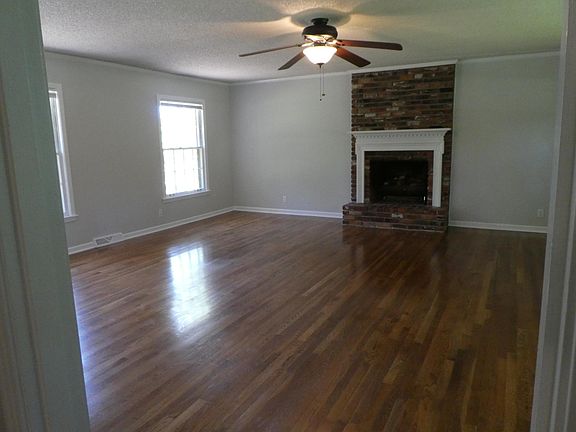 Spacious den with gas fireplace and built-in desk/bookcase.