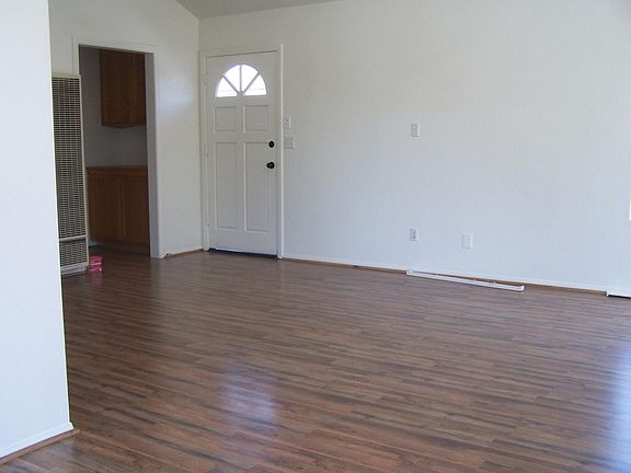 Front door to Living room with vaulted ceilings