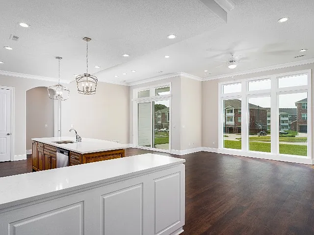 Living and dining space with floor to ceiling windows for natural light. Living and dining space with floor to ceiling windows for natural light.