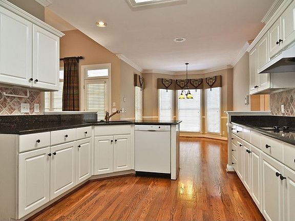 Updated kitchen-granite-tile backsplash-hardwood flooring