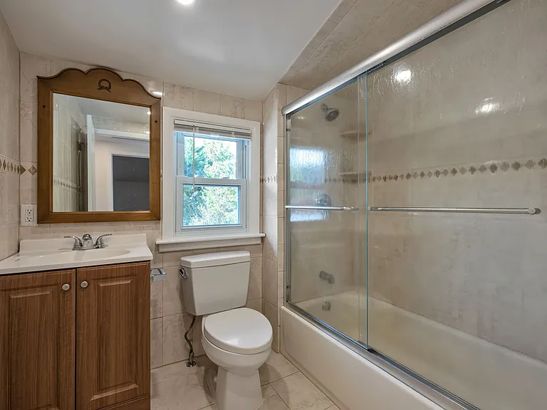 Full Hall Bath with Glass Enclosed Shower over Tub